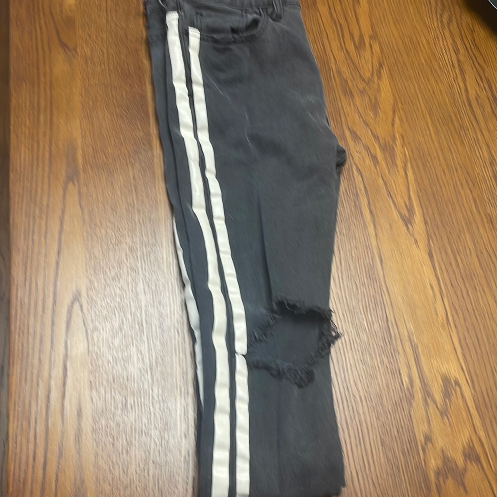 Pacasun washed ripped jeans with stripes on the sides.